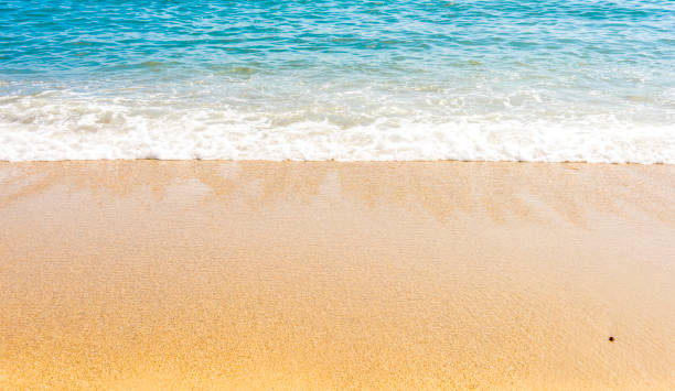 istock Soft wave of ocean on the sandy beach 1034830688
