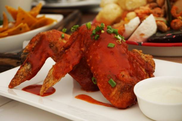 istock chicken wings deep fried with chilli sauce 1034835060