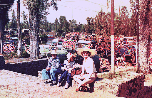 Vintage image of a mother and her children in front of Xochimilco boats.
