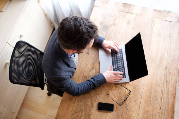 istock above of businessman working on laptop computer 1034837270
