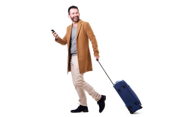 istock side portrait of man walking with mobile phone and suitcase 1034837400