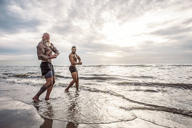 istock Tattooed Senior Man coaching young man During Workout 1034840438