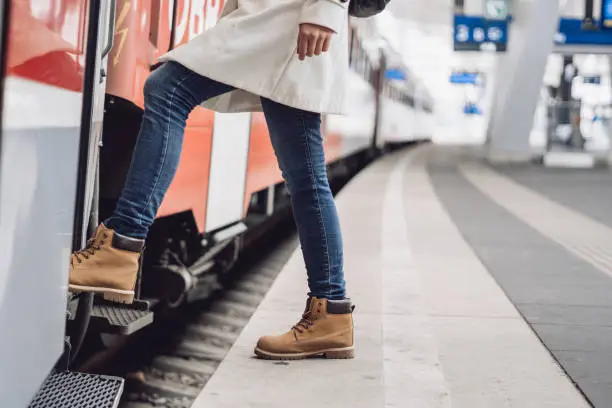 Young woman stepping in the subway train