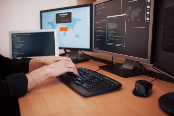 istock The young dangerous hacker breaks down government services by downloading sensitive data and activating viruses. A man uses a laptop computer with many monitors 1034843300