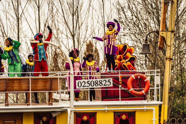 Sinterklaas arriving in The Netherlands on the steam boat Pakjesboot 12 for the traditional festival on the 5th of December The arrival of Sinterklaas in the city of Meppel on the steam boat Pakjesboot 12 coming from Spain. Sinterklaas is standing on the boat’s bow surrounded by his helpers the controversial Black Petes. The arrival in Meppel is the official arrival of Sinterklaas in The Netherlands for 2015 and is broadcasted on national television. Sinterklaas is a traditional Dutch holiday for children that is celebrated on the 5th of December. Recent years there's been a debate about the role of the Black Pete, who's figure is considered racist by some and traditional by others. zwarte piet stock pictures, royalty-free photos & images