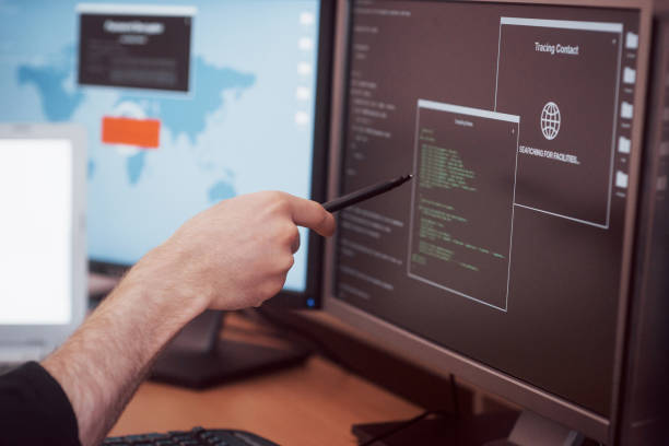 istock The young dangerous hacker breaks down government services by downloading sensitive data and activating viruses. A man uses a laptop computer with many monitors 1034843828