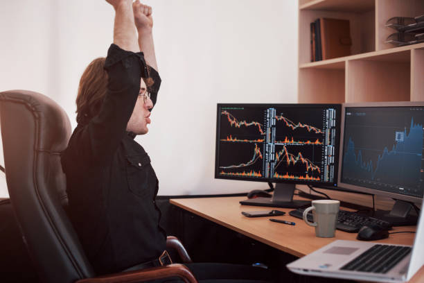istock Young stock trader broker stretching hands at workplace, he first achieved great success on the stock market 1034844644