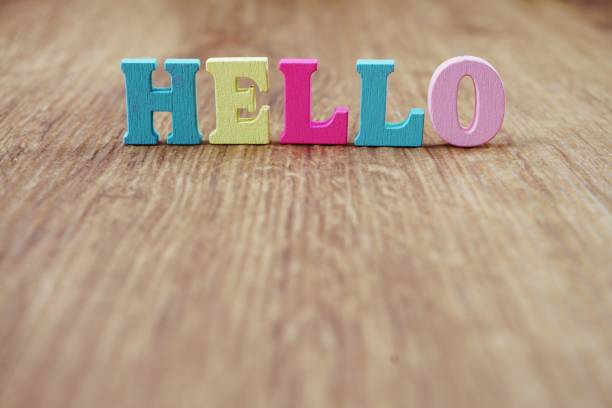 istock hello alphabet letter with space copy on wooden background 1034845574