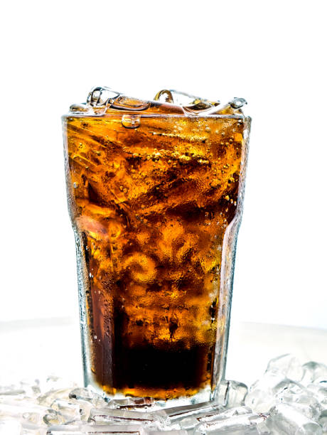 istock Cola with ice cubes in tall glass on white background 1034847776