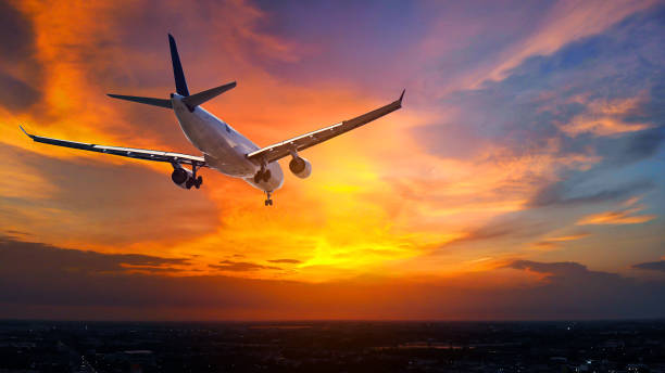 istock Airplane in the sunset sky flight travel transport airline background concept. 1034848708