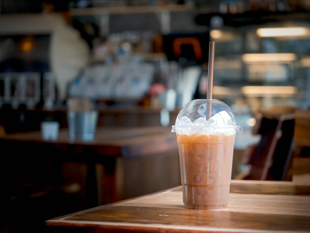 Glass of iced black coffee on wood table at coffee shop.
