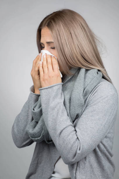 istock Woman is rubbing her nose 1034849702