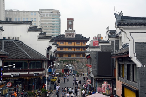 People walking in Ningbo pedestrian shopping street, at the old Drum Tower complex. Zhejiang province, China