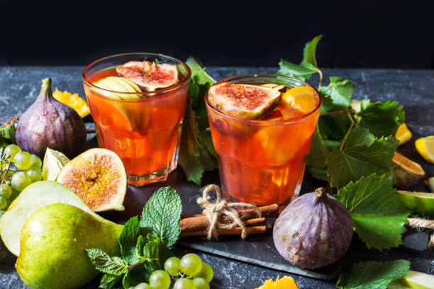 istock Cocktail fruit sangria with apples, orange, figs, grapes on stone table 1034863434