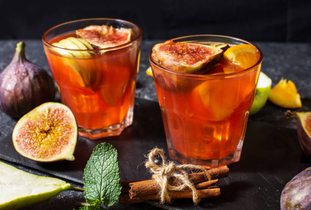 istock Cocktail fruit sangria with apples, orange, figs, grapes on stone table 1034863494