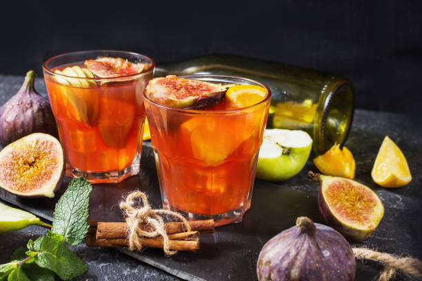 istock Cocktail fruit sangria with apples, orange, figs, grapes on stone table 1034863842