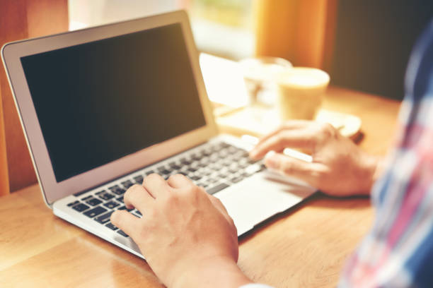 istock Cropped Hands Of Woman Using Laptop At Table 1034864428