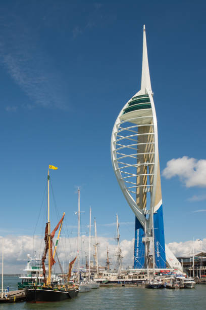 Spinnaker Tower at Gunwharf Quays in Portsmouth Harbour, Hampshire, England. With moored boats and sailing ships.
