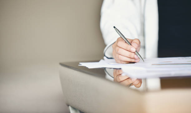 istock Midsection Of Businessman Doing Paperwork On Desk In Office 1034873480