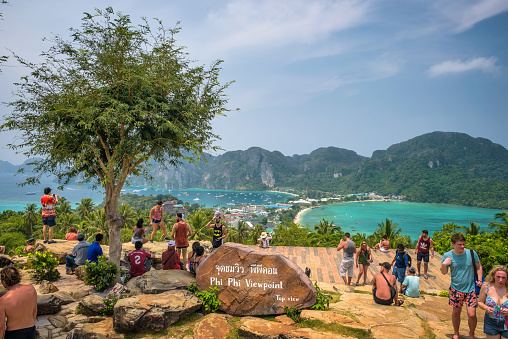 Phi Phi, Thailand - April 4, 2018 : Tourists enjoy panoramic view over the Tonsai Village and the mountains of Koh Phi Phi Island in Thailand.