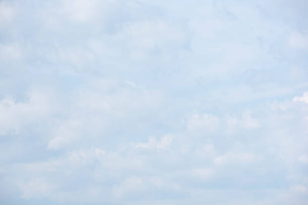 istock Beautiful white fluffy clouds on a blue sky 1034881176