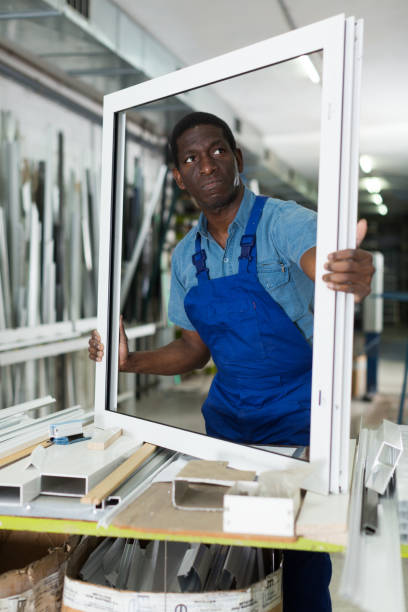 istock Adult man master is looking on modern window frame 1034882848
