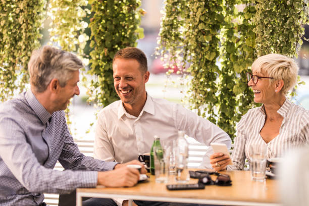 istock Happy business colleagues talking on a coffee break in a cafe. 1034892496