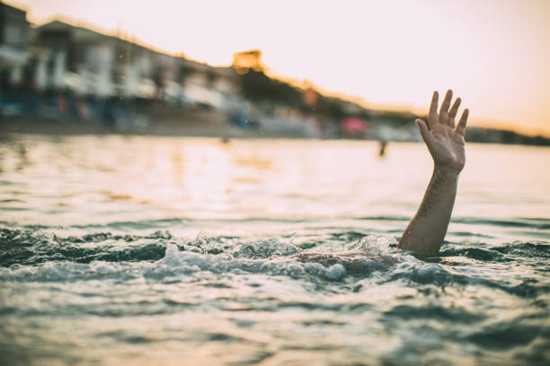 istock Young man drowning in the sea 1034893668