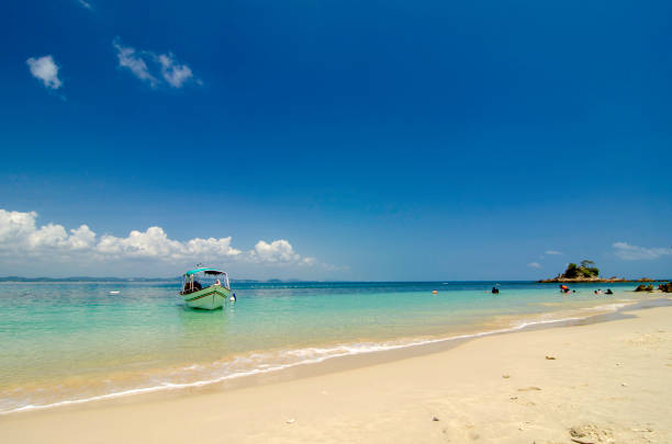 istock Beautiful tropical beach at sunny day with blue sky background 1034893742