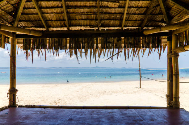 istock beautiful tropical beach with white sandy beach from bamboo hut. beach volley ball net on background. 1034893760