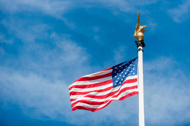 istock Low Angle View Of American Flag Against Sky 1034901334