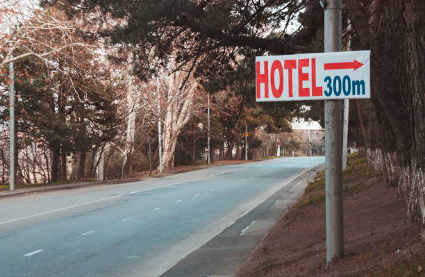 istock Road Sign By Trees In City 1034902512