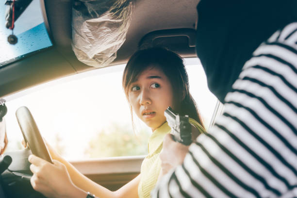 istock Thief Threatening Young Woman With Gun In Car 1034906664