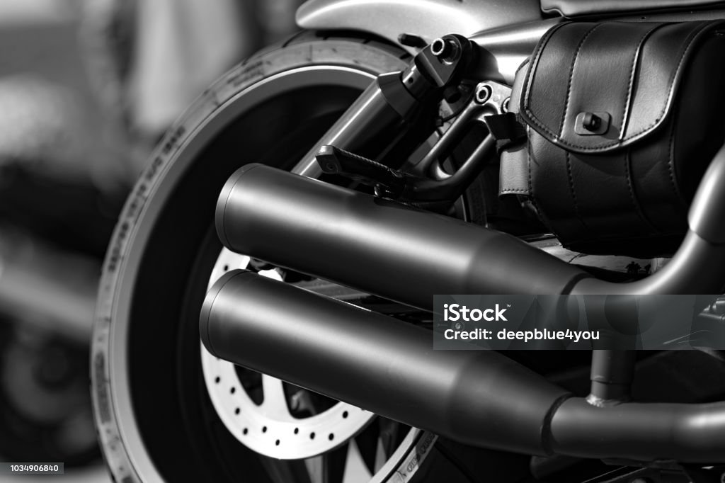 Motorcycle tire and exhaust Close up of a parked motorbike with fokus on the exhaust on a public park deck in Hamburg, Germany. Cannon prime lens used for this shot Motorcycle Stock Photo