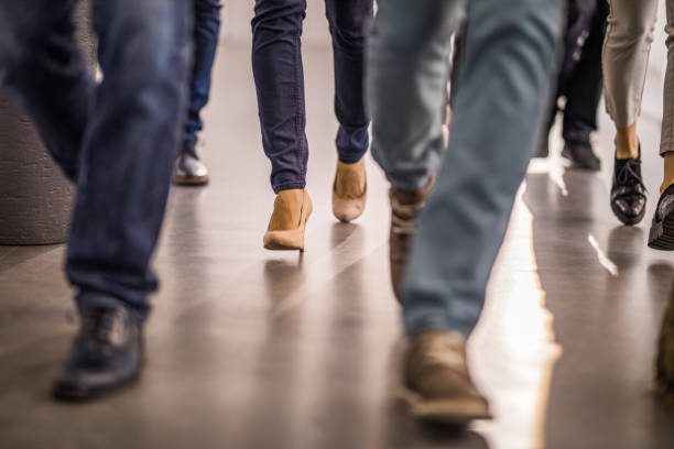 istock Large group of unrecognizable people running through corridor. 1034910792