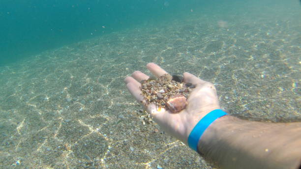 istock Natural sunbeams underwater with rocks 1034911114