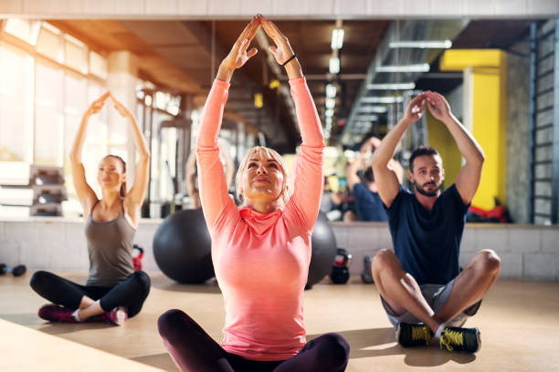 istock Young tired athletes in a gym stretching their muscles after pilates class. 1034913506