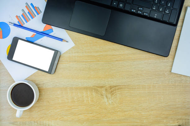 istock Office desk with a laptop, report graph chart, pen,smart phone.Workplace concept. 1034927702