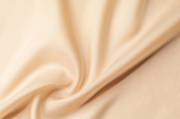 istock Texture background of fabric. Beige fabric. Silk fabric wallpaper texture background pattern in sepia pastel yellow cream beige tint: Lovely natural silk textured textile 1034931322
