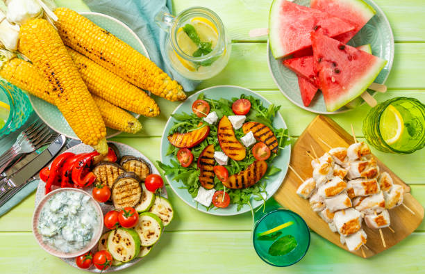 istock Summer bbq party concept - grilled chicken, vegetables, corn, salad, top view 1034954140
