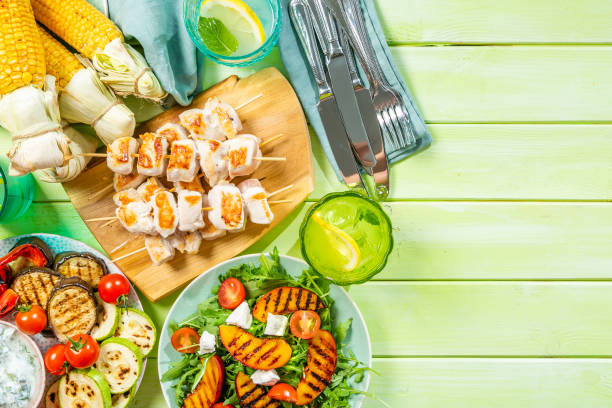 istock Summer bbq party concept - grilled chicken, vegetables, corn, salad, top view 1034954428