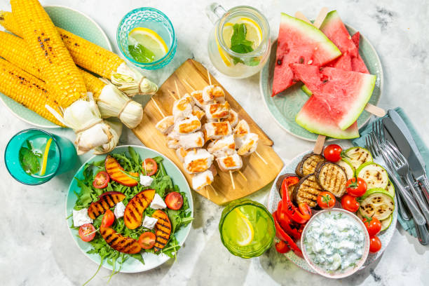 istock Summer bbq party concept - grilled chicken, vegetables, corn, salad, top view 1034954650