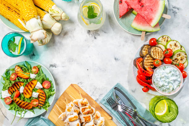 istock Summer bbq party concept - grilled chicken, vegetables, corn, salad, top view 1034954774