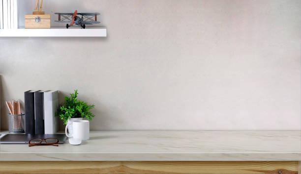 istock Workspace marble table with laptop coffee mug, flower, notebook and copy space. 1034963362