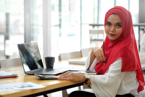 istock Attractive female Arabic corporate worker working on laptop computer on desk 1034963368