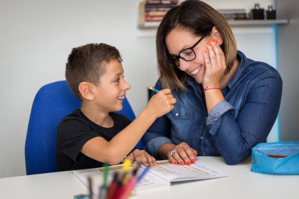 istock Mother and son doing his homework together 1034964684