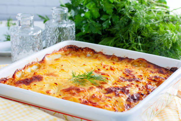 istock Potato casserole with ruddy crust on white table, selective focus, horizontal 1034964750