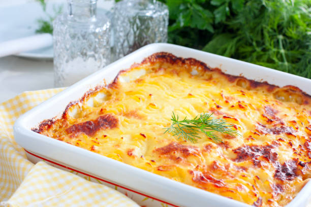 istock Potato casserole with ruddy crust on white table, selective focus, horizontal 1034964778