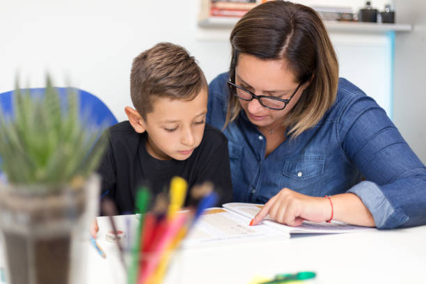 istock Mother is helping her son to finish his homework 1034968590