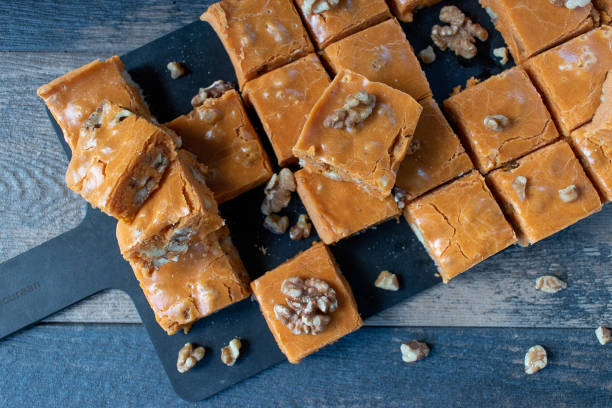 istock Pumpkin fudge squares with walnuts in cute Halloween setting 1034971836